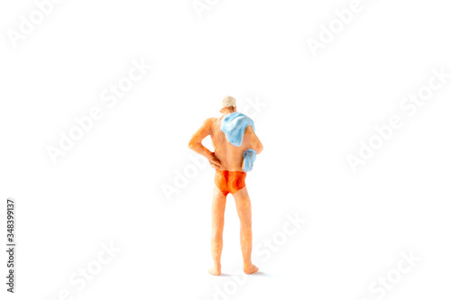 Miniature people wearing swimsuit  standing on white background , Summer time concept © Sirichai Puangsuwan