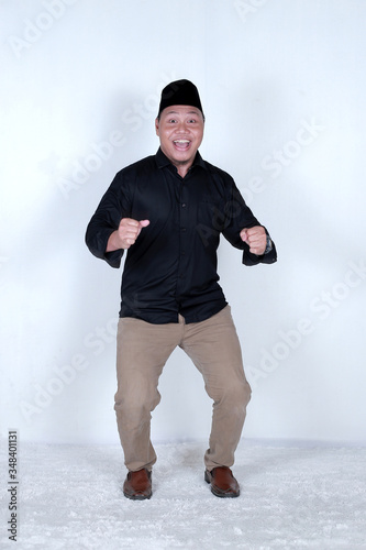 the expression of Asian Muslim men running when happiness has arrived 