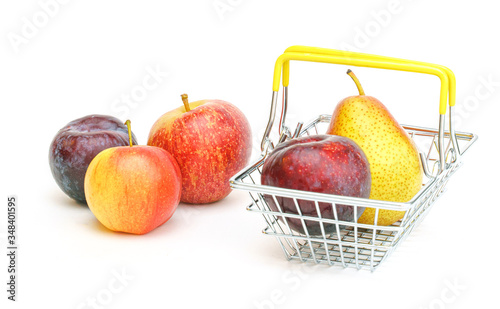 a small shopping basket with fruits, apples, pears and plums on a white background.