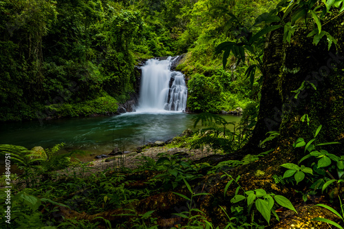 Waterfall landscape. Beautiful hidden Canging waterfall in tropical jungle in Sambangan, Bali. Slow shutter speed, motion photography. photo