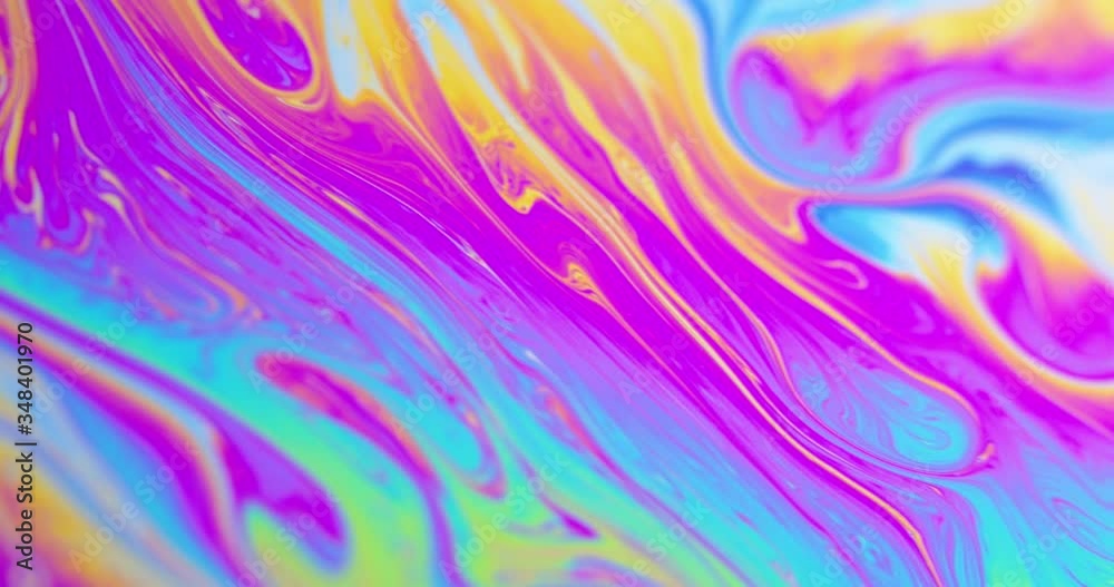 Surface of Liquid Soap with Changing Rainbow Colours. Macro.