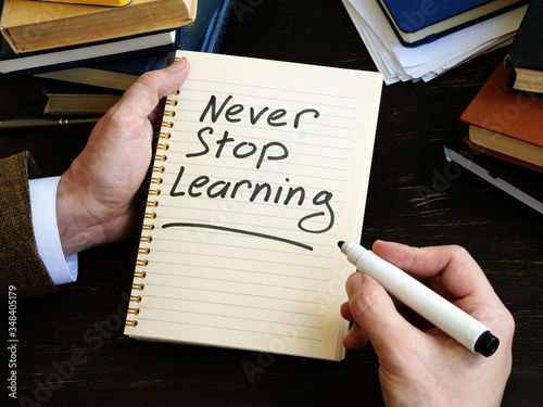 Never stop learning written by man phrase. photo