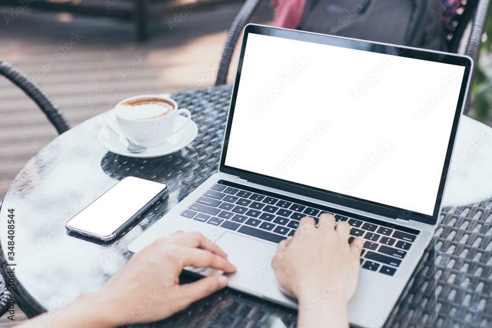 computer,cell phone mockup image blank screen with white background for advertising,hand woman work using laptop texting mobile contact business search information on desk in cafe.marketing,design