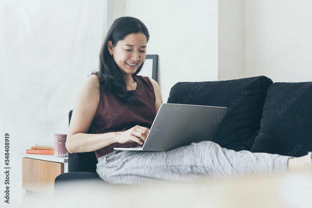 using computer.hand typing keyboard laptop online chatting search form internet while working sitting on sofa.concept for work from home.technology device contact communication business people using computer.hand typing keyboard laptop online chatting search form internet while working sitting on sofa.concept for work from home.technology device contact communication business people
