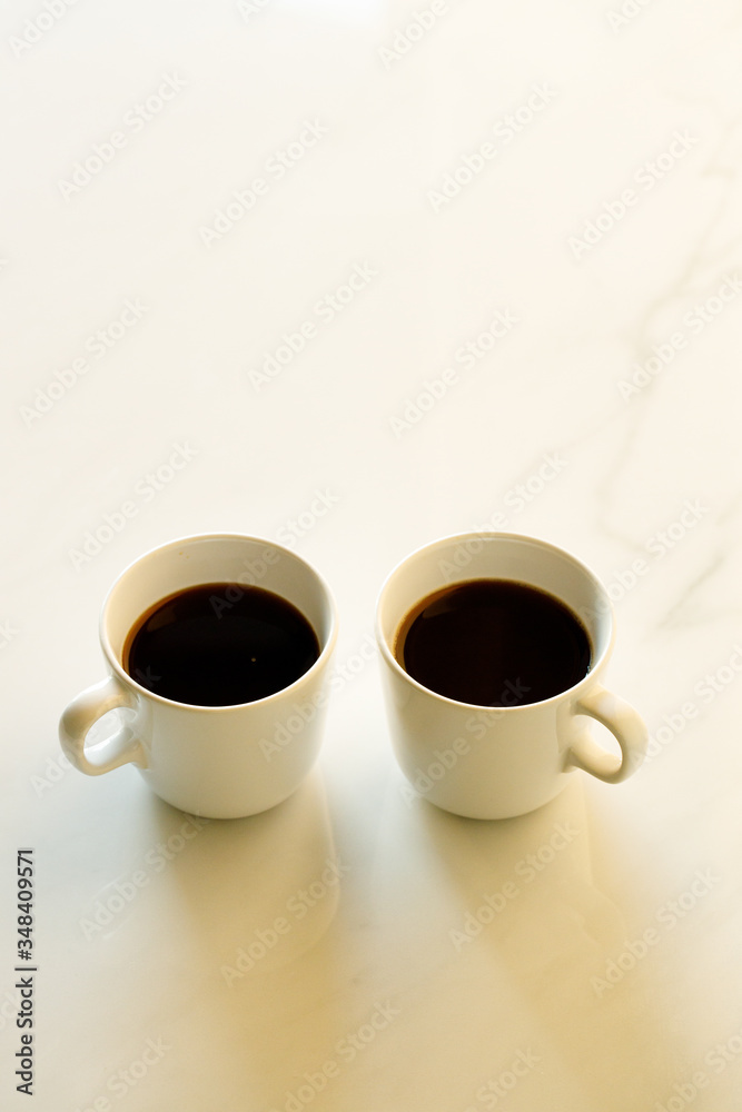 cups of coffees on white marble table in morning light cups of coffees on white marble table in morning light