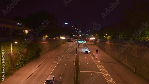 Timelapse of driving cars, traffic at night in Munich city, stop and go at the Effnerplatz with famous architecture elements. photo