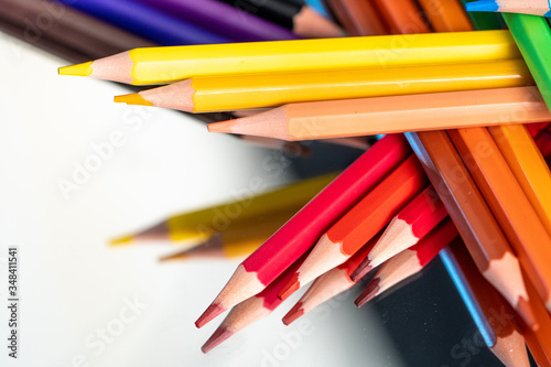 Many different colored pencils on white