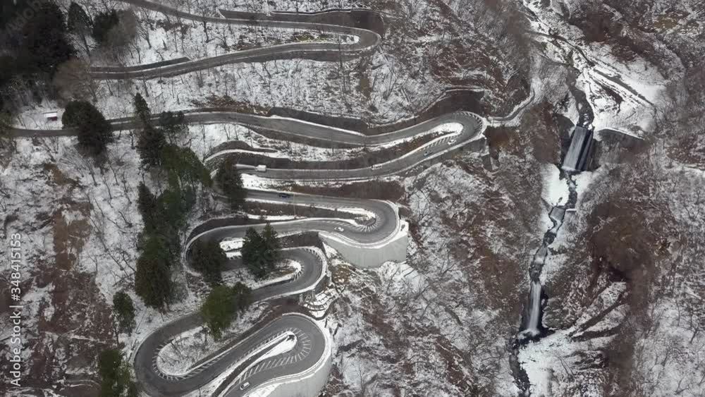 Looking down on traffic moving along the wintery Irohazaka Winding Road, Nikko, Tochigi, Japan Looking down on traffic moving along the wintery Irohazaka Winding Road, Nikko, Tochigi, Japan