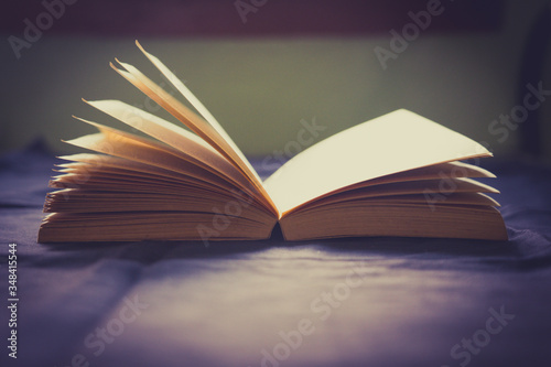 A bright beautiful picture of an open book against sunlight