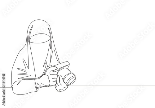 One continuous line drawing of young happy saudi arabian muslimah wearing burqa while holding dslr camera. Traditional Islamic woman niqab dress concept single line draw design vector illustration