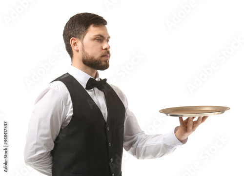 Handsome male waiter on whi...