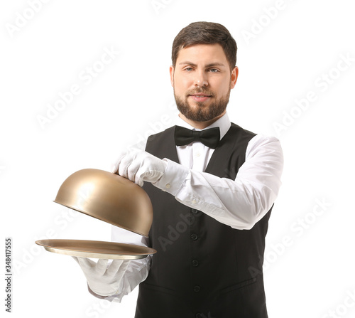 Handsome male waiter on whi...