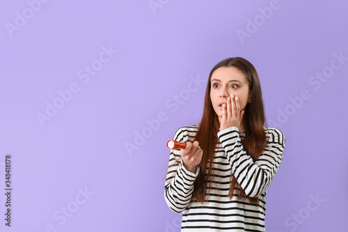 Shocked woman with flashlig...