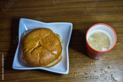 india most common ban makkhan and tea on a yellow wooden background, Indian Food photo