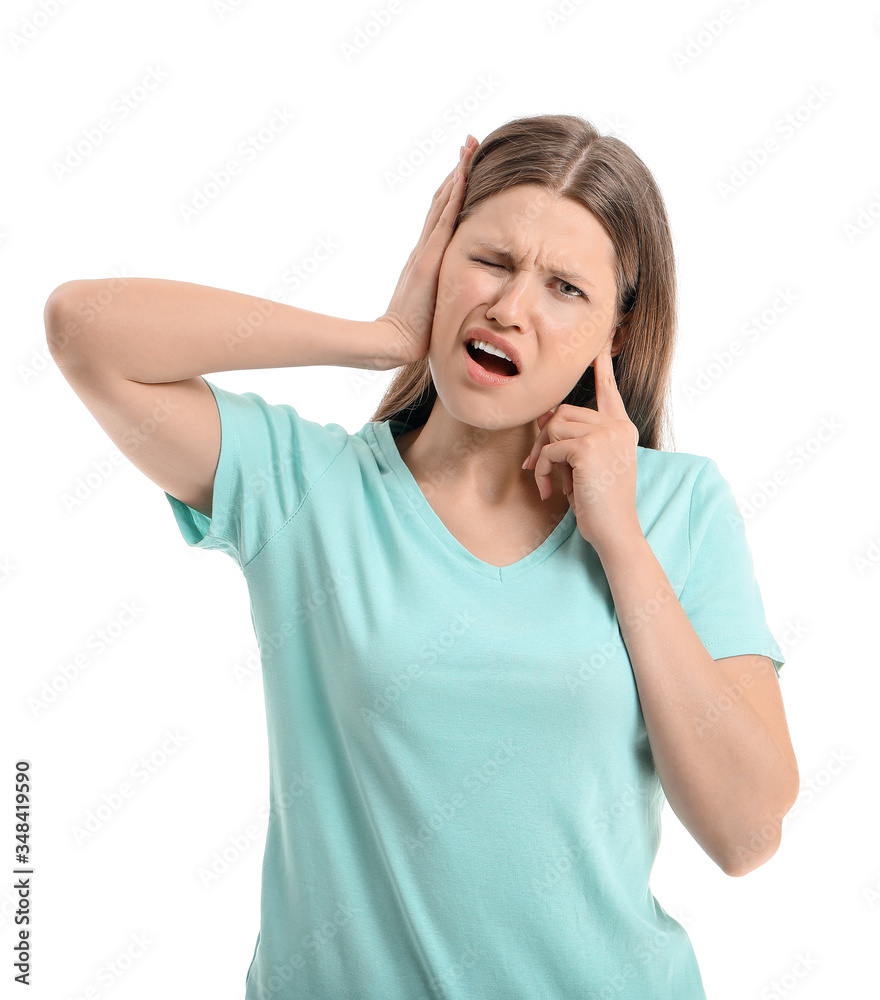 Young woman suffering from loud noise on white background Young woman suffering from loud noise on white background