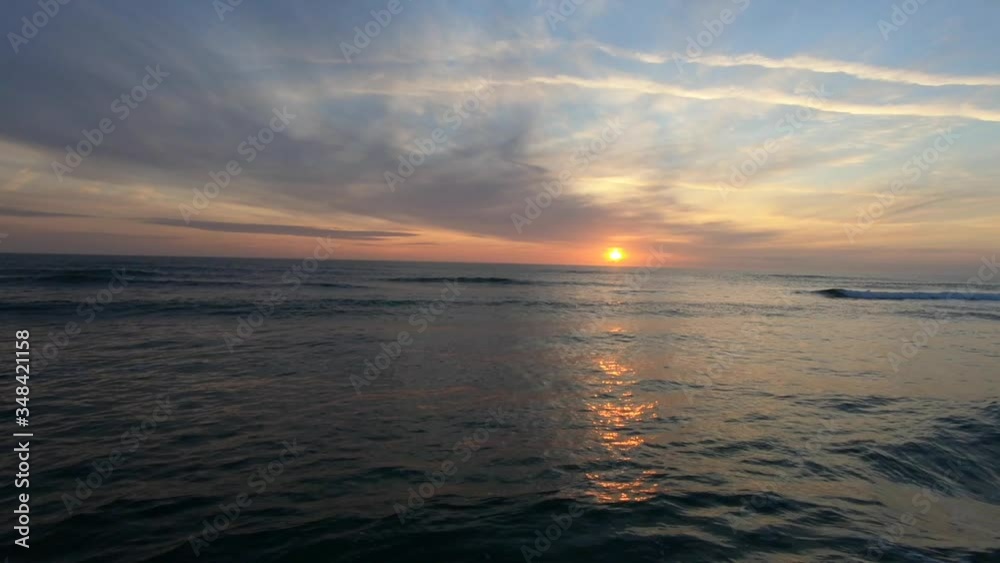 Awesome Sunrise over ocean while ocean waves roll towards shore. Awesome Sunrise over ocean while ocean waves roll towards shore.