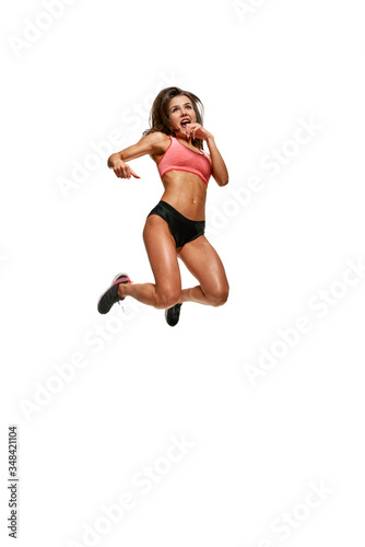 Full photo of athletic muscular woman jumping on white background