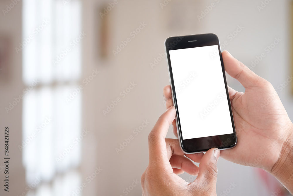 Cropped shot view of man hands holding smart phone with blank copy space screen for your text message or information content, female reading text message on cell telephone during in urban setting. Cropped shot view of man hands holding smart phone with blank copy space screen for your text message or information content, female reading text message on cell telephone during in urban setting.
