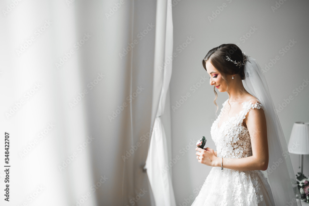 Portrait of stunning bride with long hair posing with great bouquet Portrait of stunning bride with long hair posing with great bouquet