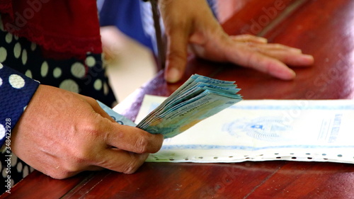 BLURRY and soft focus images of, someone when receiving cash, Batang Indonesia photo