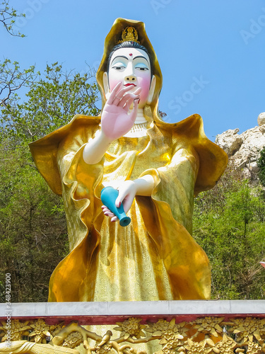 Chonburi, Thailand - April, 23, 2008 : An Elegant Statue of Bodhisattva Guan Yin wearing a golden dress is the most famust destinations located on Khao Sam Muk, Chonburi province photo