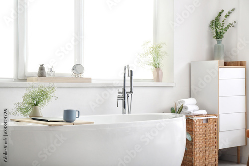 Interior of modern bathroom with floral decor