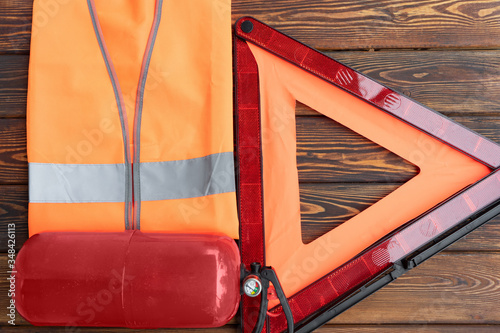 Red triangle road safety, a fire extinguisher and fluorescent reflective vest, top view