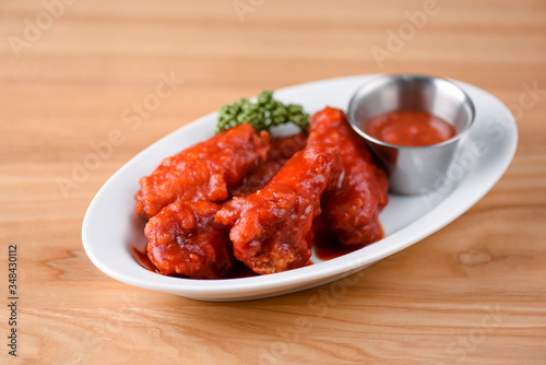 Buffalo chicken wings with hot tomato dip. Chicken meat in hot spicy sauce. Spicy food.