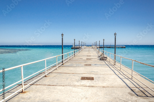 pier leading to the sea on a sunny day empty pier overlooking the sea on a sunny day