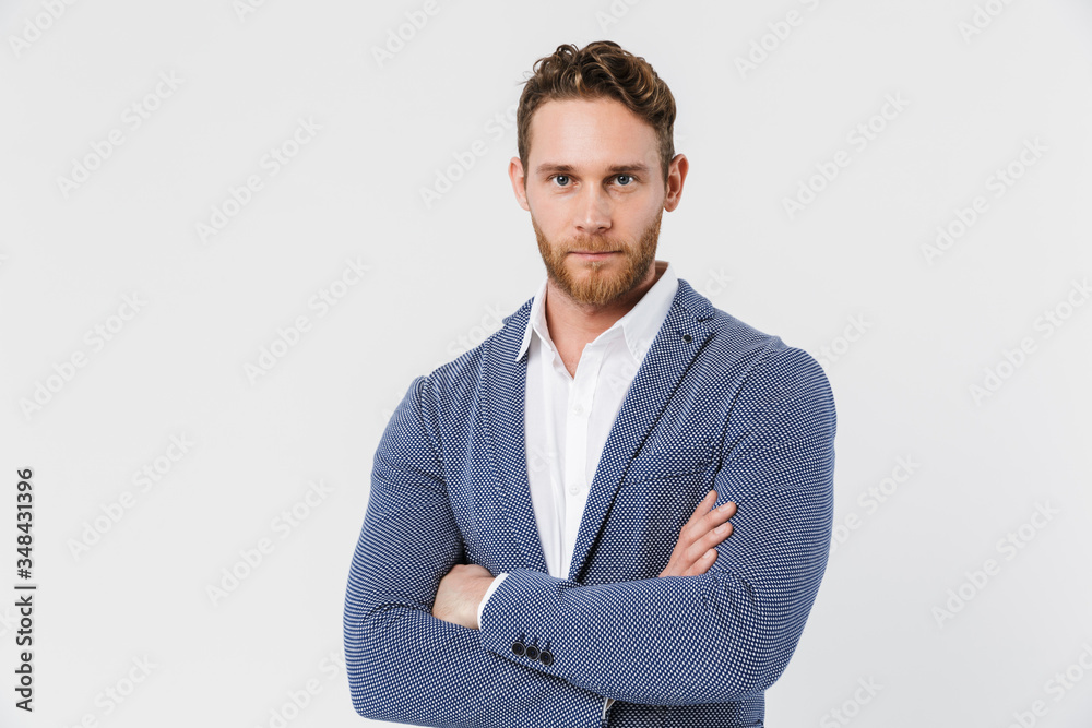 Image of pleased young man posing on camera with hands crossed Image of pleased young man posing on camera with hands crossed