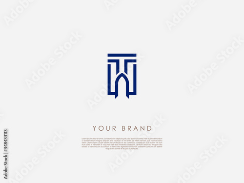 a dark blue rectangular business logo which includes letter 't' and an arched door of an old building