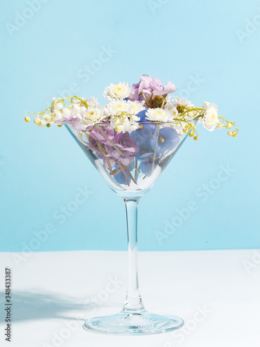 A bouquet of flowers in a wine glass. Creative concept of winemaking.