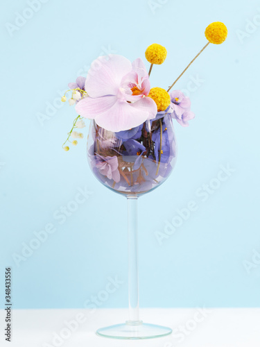 A bouquet of flowers in a wine glass. Creative concept of winemaking.