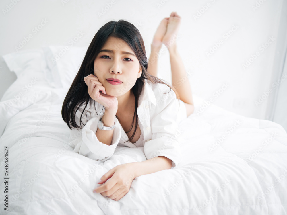 Happy Asian woman relaxing on bed, lifestyle concept. Happy Asian woman relaxing on bed, lifestyle concept.