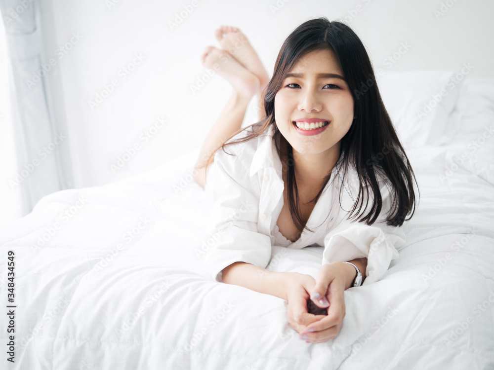 Happy Asian woman relaxing on bed, lifestyle concept. Happy Asian woman relaxing on bed, lifestyle concept.