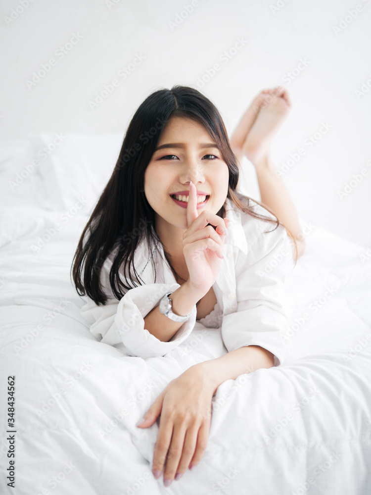 Happy Asian woman relaxing on bed, lifestyle concept. Happy Asian woman relaxing on bed, lifestyle concept.