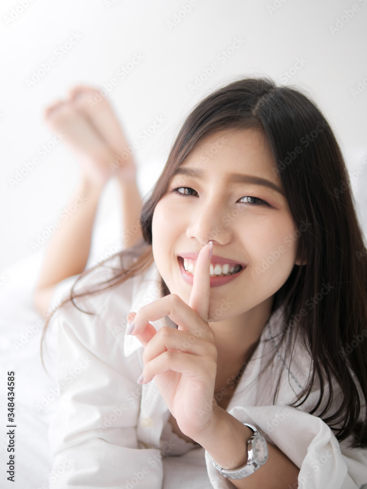 Happy Asian woman relaxing on bed, lifestyle concept. Happy Asian woman relaxing on bed, lifestyle concept.