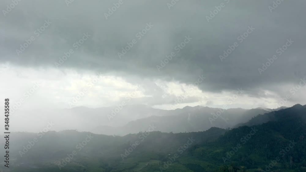 Aerial hyperlapse from drone flying into rain storm 