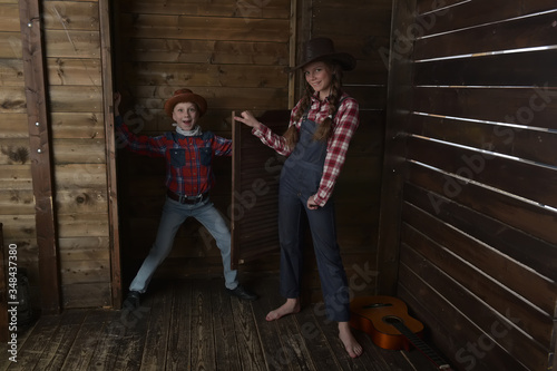 brother and sister in cowboy hats photo