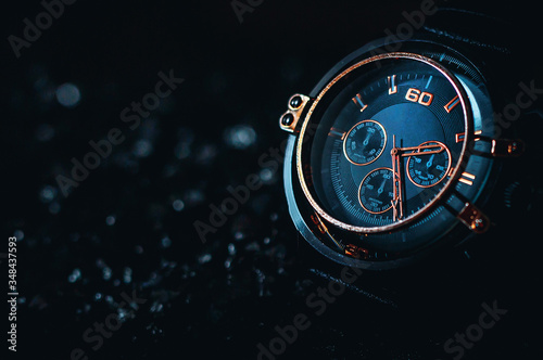 Metallic gold Phantom Blue men's watch on a black background.  photo