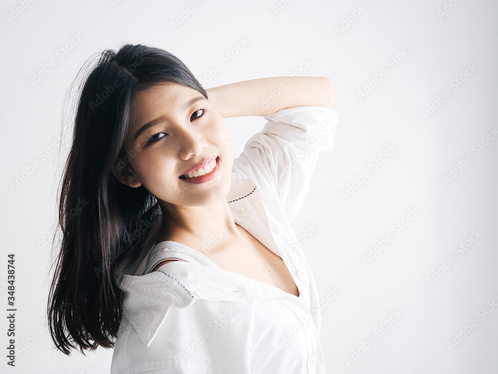 Happy Asian woman relaxing on bed, lifestyle concept.