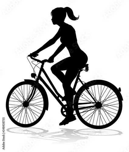 A woman bicycle riding bike cyclist in silhouette