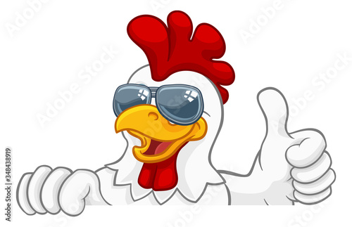 Fotografia A chicken rooster cockerel bird cartoon character peeking over a sign and giving