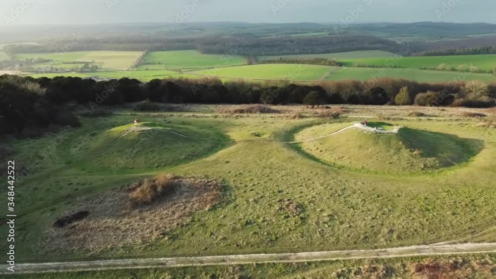Drone shot of devil's humps, viking burial mounds, at kingley vale reserve in south england. Panning shot, high angle Drone shot of devil's humps, viking burial mounds, at kingley vale reserve in south england. Panning shot, high angle