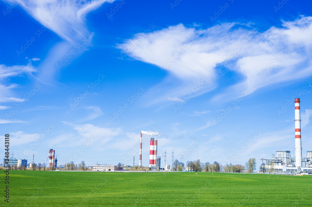 Chemical plant on the background of the field