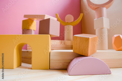 A town made of elements of a wooden children's designer of pastel colors.