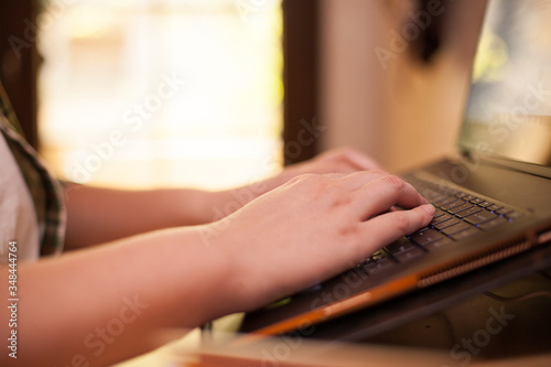 Close up of businesswoman working on laptop from home during covid-19