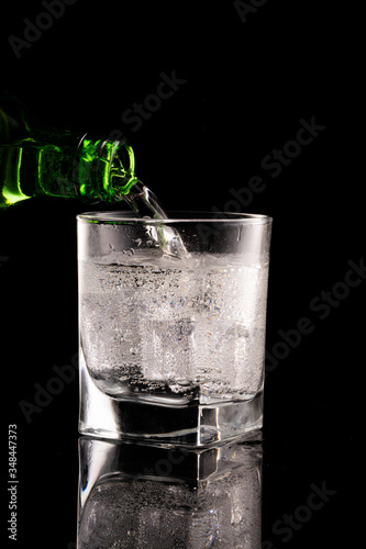 Glass of mineral water on black background