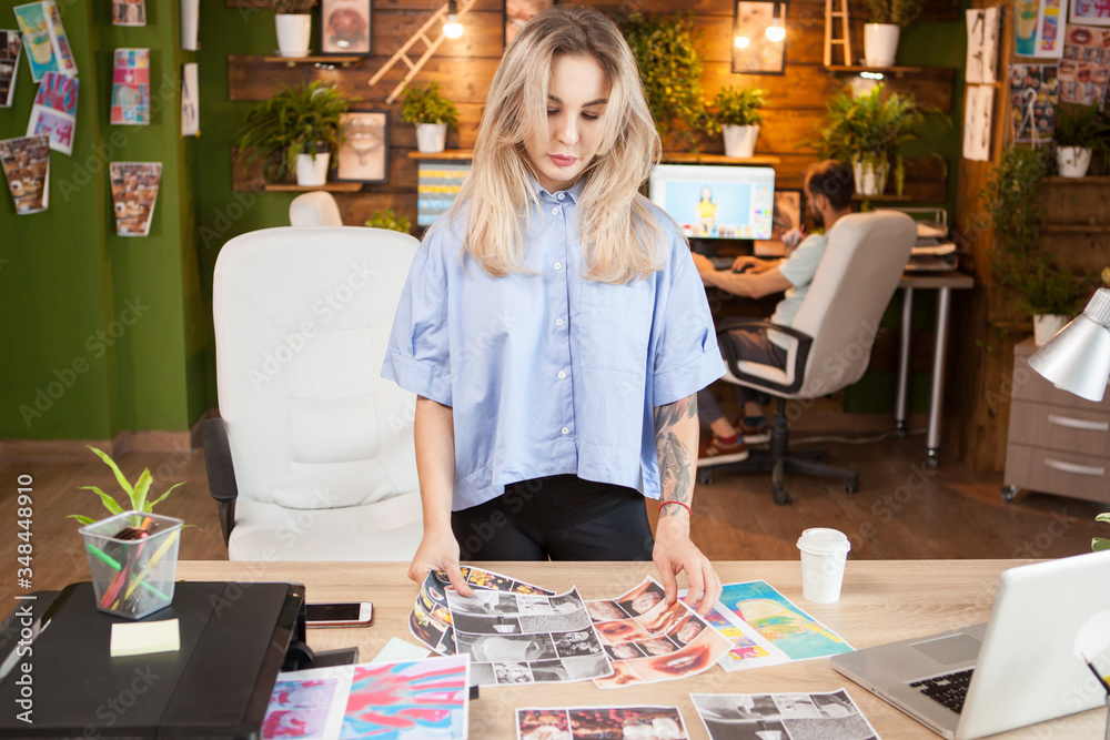 Creative female dressmaker working in a modern office. Woman in stylish clothes.