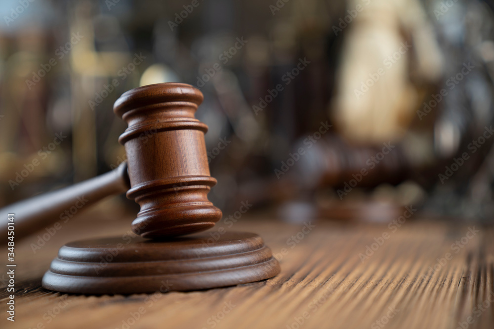 Lawyers office concept. Law symbols composition - gavel and Themis statue on rustic wooden desk. Lawyers office concept. Law symbols composition - gavel and Themis statue on rustic wooden desk.
